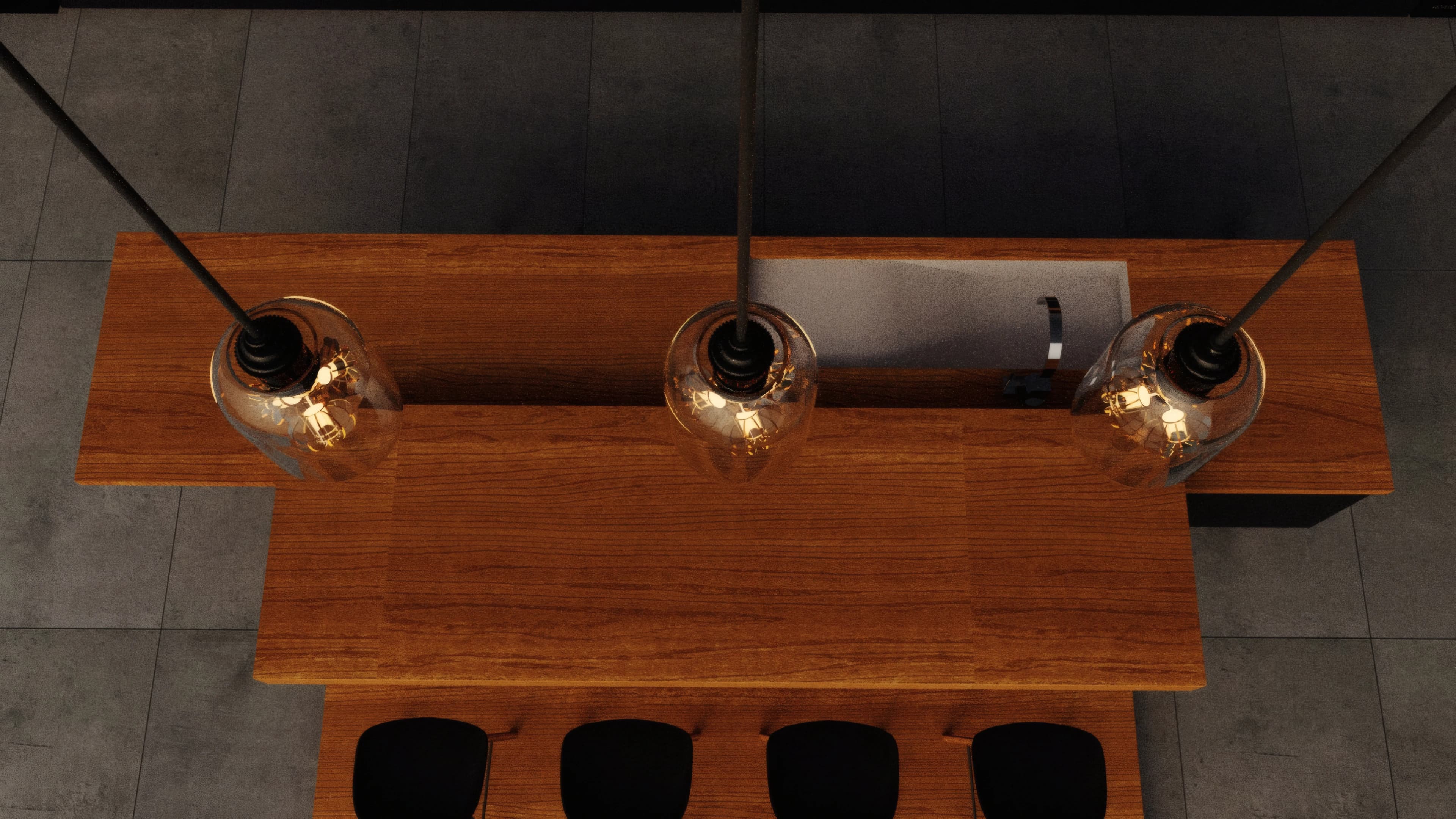 Three filament pendants arranged over a timber dining table