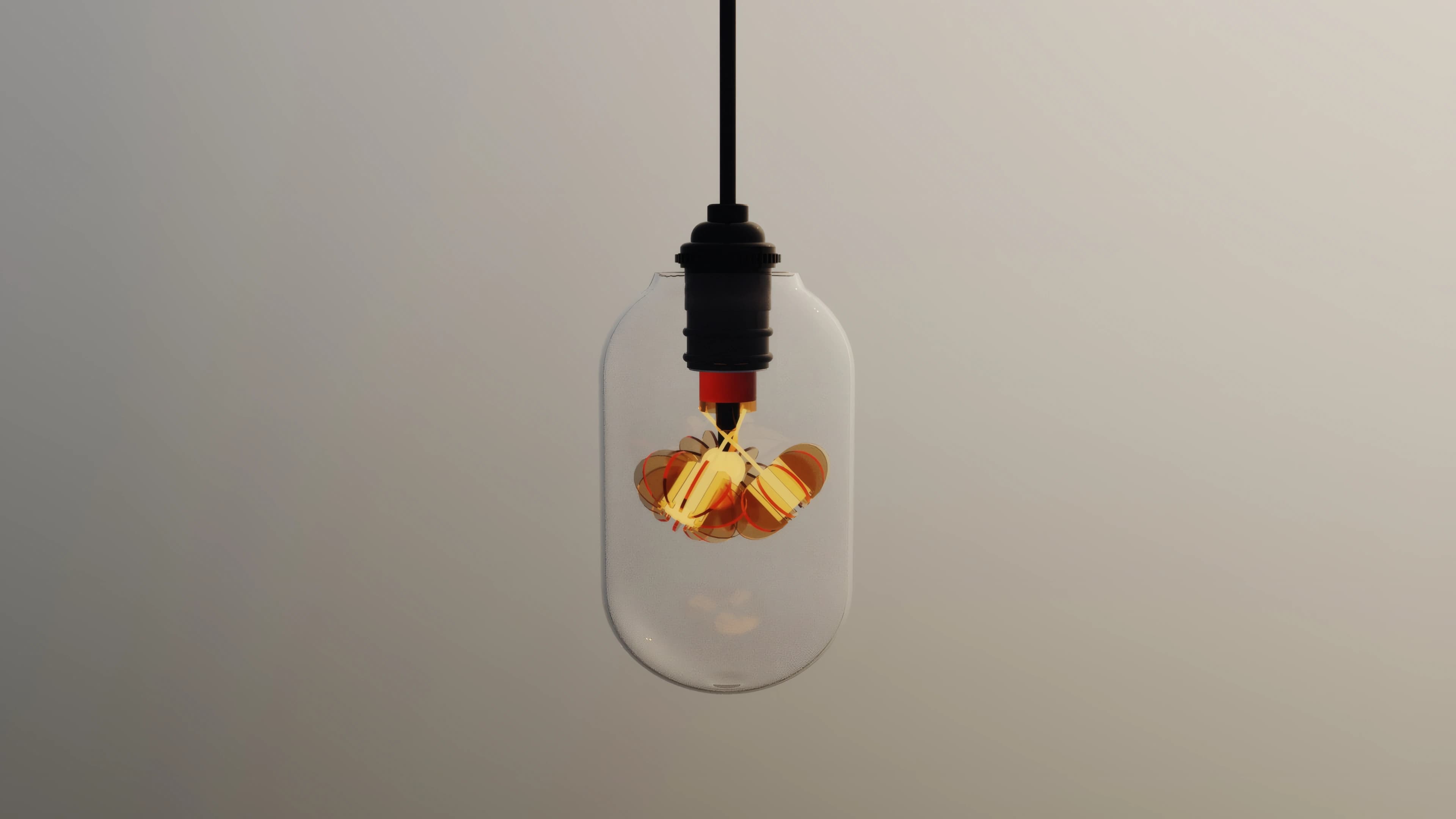 A single Filament pendant suspended against a pale wall