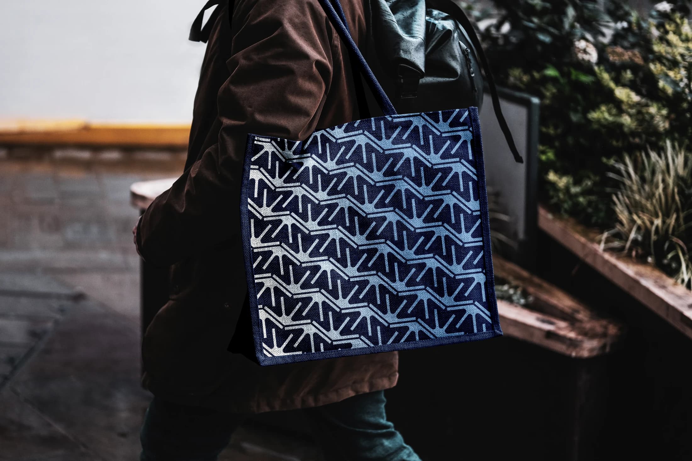 A tote-bag mockup carrying the repeated London Valley emblem
