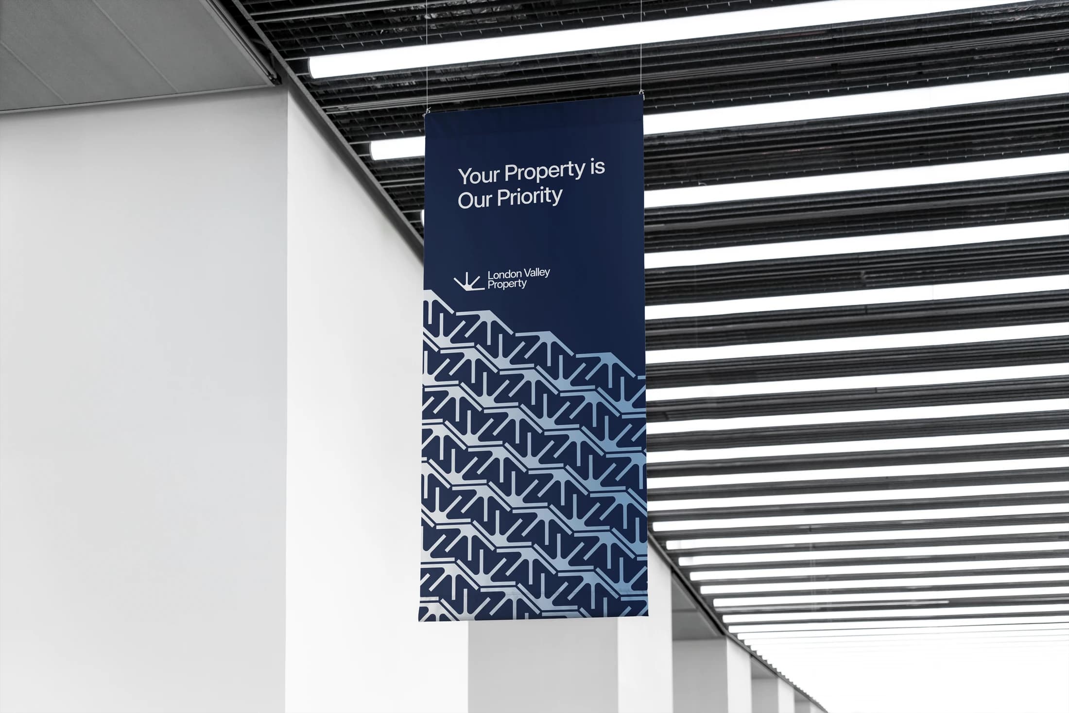 A hanging flag mockup with the blue geometric brand pattern